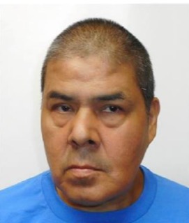 Man with short dark hair and a blue shirt.