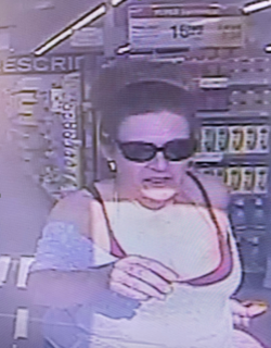 Person wearing sunglasses and a white tank top