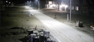 Empty street at night, lit by streetlights