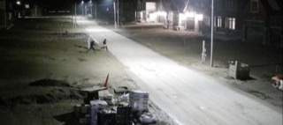 Empty street at night, two figures walking away
