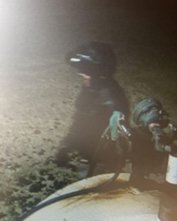 Person in dark gear, obscured by shadow