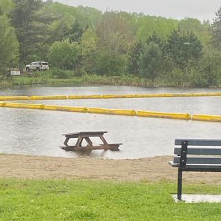 Picnic table partially submerged in water.
