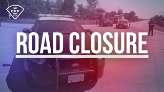 Police cruiser blocking a road.