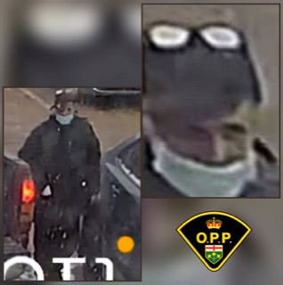 Person wearing a dark coat and glasses.