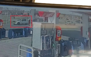 White SUV parked near a building.