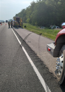 Semi-truck and emergency responders on the shoulder of a highway
