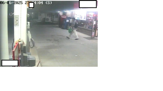 Person walking near gas pumps