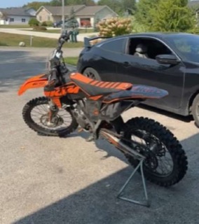 Orange and black dirt bike on a stand