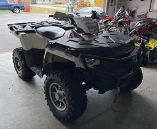 White four-wheeler with black accents and knobby tires