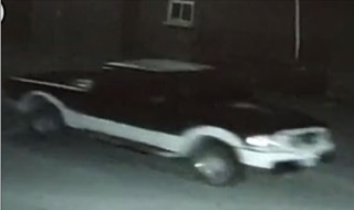 Black car with white stripe, side view