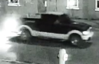 Black pickup truck parked on a street.