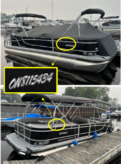 Black pontoon boat docked on water