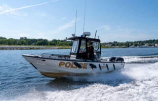 Police boat moving through water.