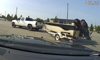 White pickup truck towing a boat