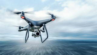 Drone in flight against a blurred sky