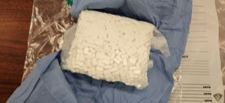 White powdery substance wrapped in clear plastic.