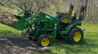 Green tractor with a front-end loader