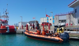 Coast Guard rescue boat docked at a pier.