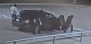 Dark SUV parked on pavement.