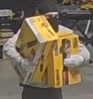 Person holding a yellow box, wearing gloves