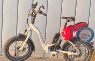 Electric bike with a red cargo bag, "Dad Power Bikes" text on frame, "Arro" on tire