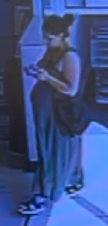 Person in a dark dress and sunglasses