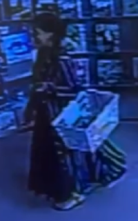 Person holding a box in a store.