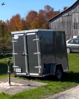 Black utility trailer with a license plate B11-53