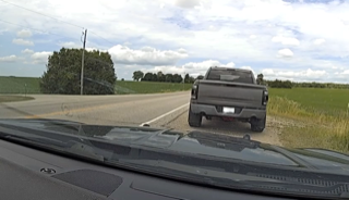 Gray pickup truck on a rural road