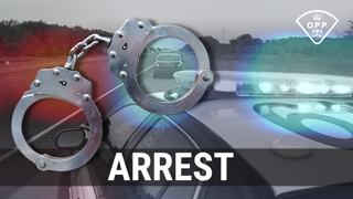 Handcuffs over a blurred image of a police car and highway. ARREST