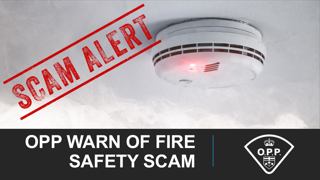 Fire alarm on ceiling, red light flashing