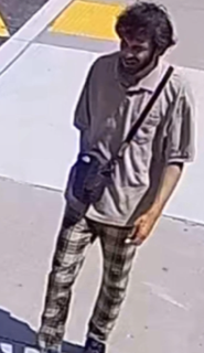 Person wearing a gray t-shirt and dark pants.