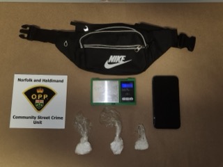 Black fanny pack with Nike logo Small baggies of white powder Digital scale