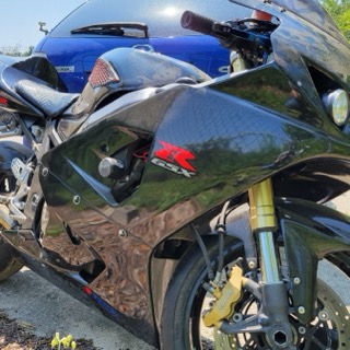 Black Suzuki GSX motorcycle, gold forks, yellow brake calipers