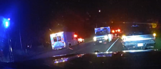 Ambulance and emergency vehicles on a dark road