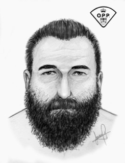 Man with a full beard, looking forward.