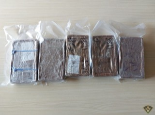 Five packages of a brown substance