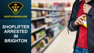 Man in a red sweatshirt and jeans, holding a package