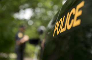 Police helmet, green foliage in background