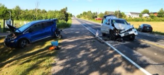 Two cars involved in a collision on a two-lane road.