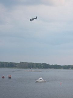 Helicopter flying over a body of water.