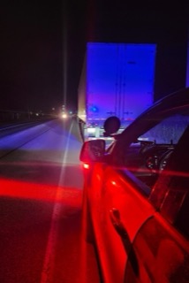 Truck with blue trailer, red brake lights