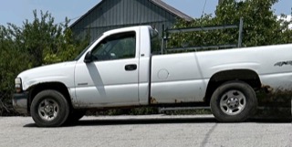 White pickup truck with a utility rack in the bed
