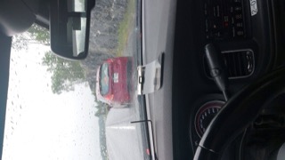 Rainy road and red car ahead