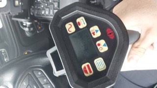 Close-up of a control panel with buttons and a digital display.