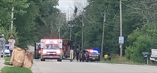 Ambulance, police car, and tow truck at an accident scene.