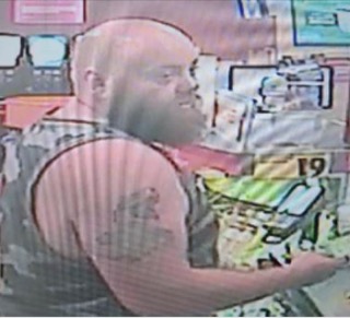 Man holding a green and yellow sign