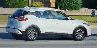 White Nissan Kicks crossover SUV, side view
