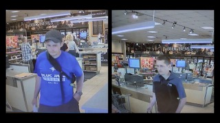 Man in a blue shirt and baseball cap, facing left. Retail store interior, shelves of beverages.