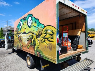 Green alligator mural on a delivery truck